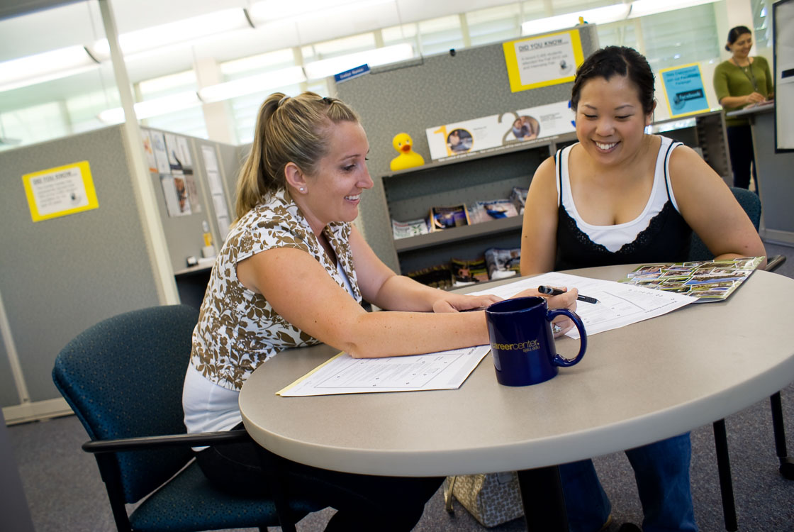 two people sitting at a desk