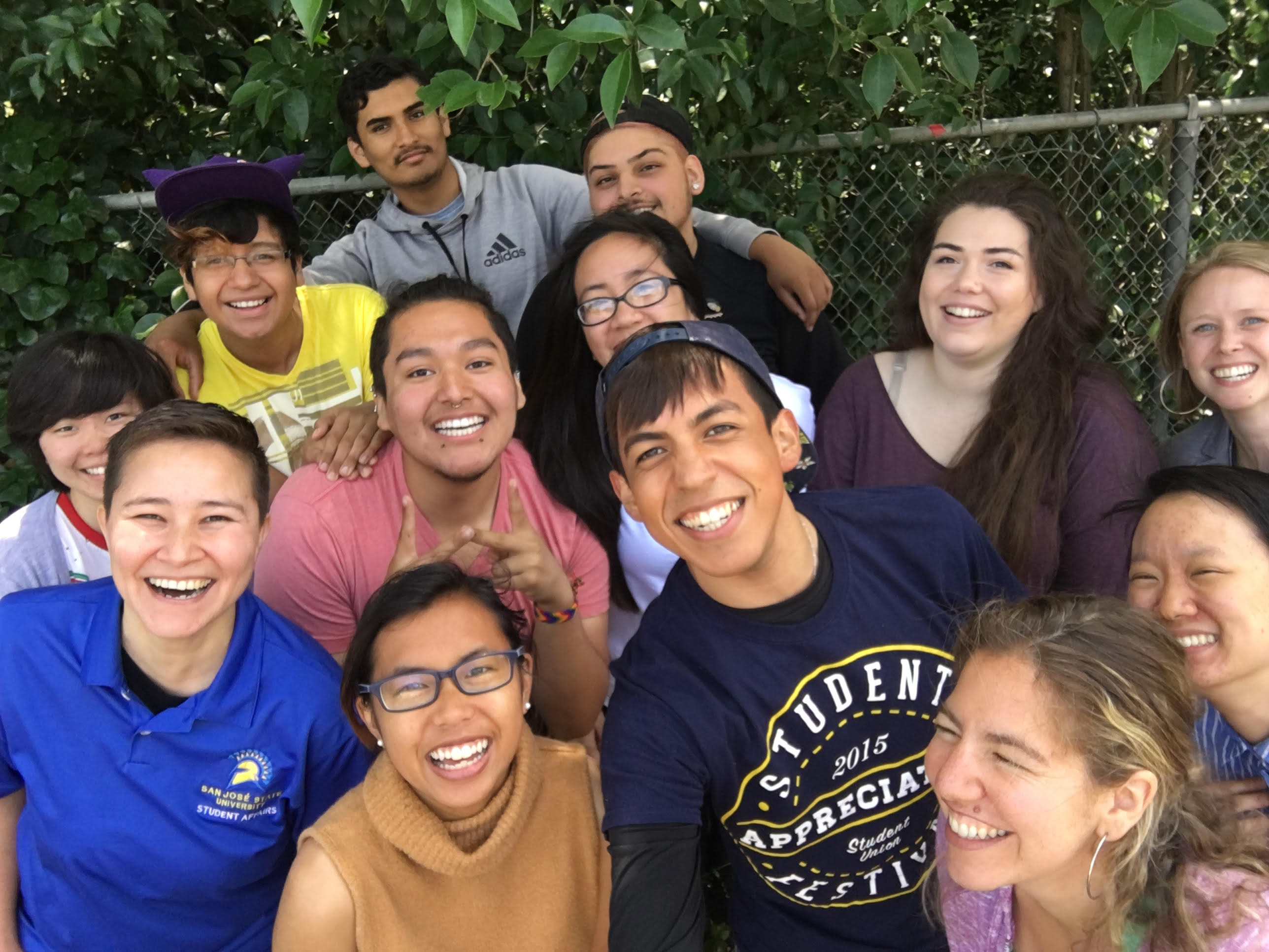 Peers in PRIDE mentors pose for a photo outside.