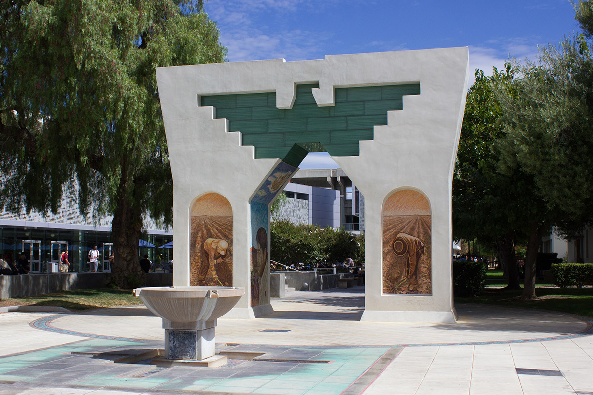 Cesar Chavez arch with farm workers in mosaic tile on each pillar.