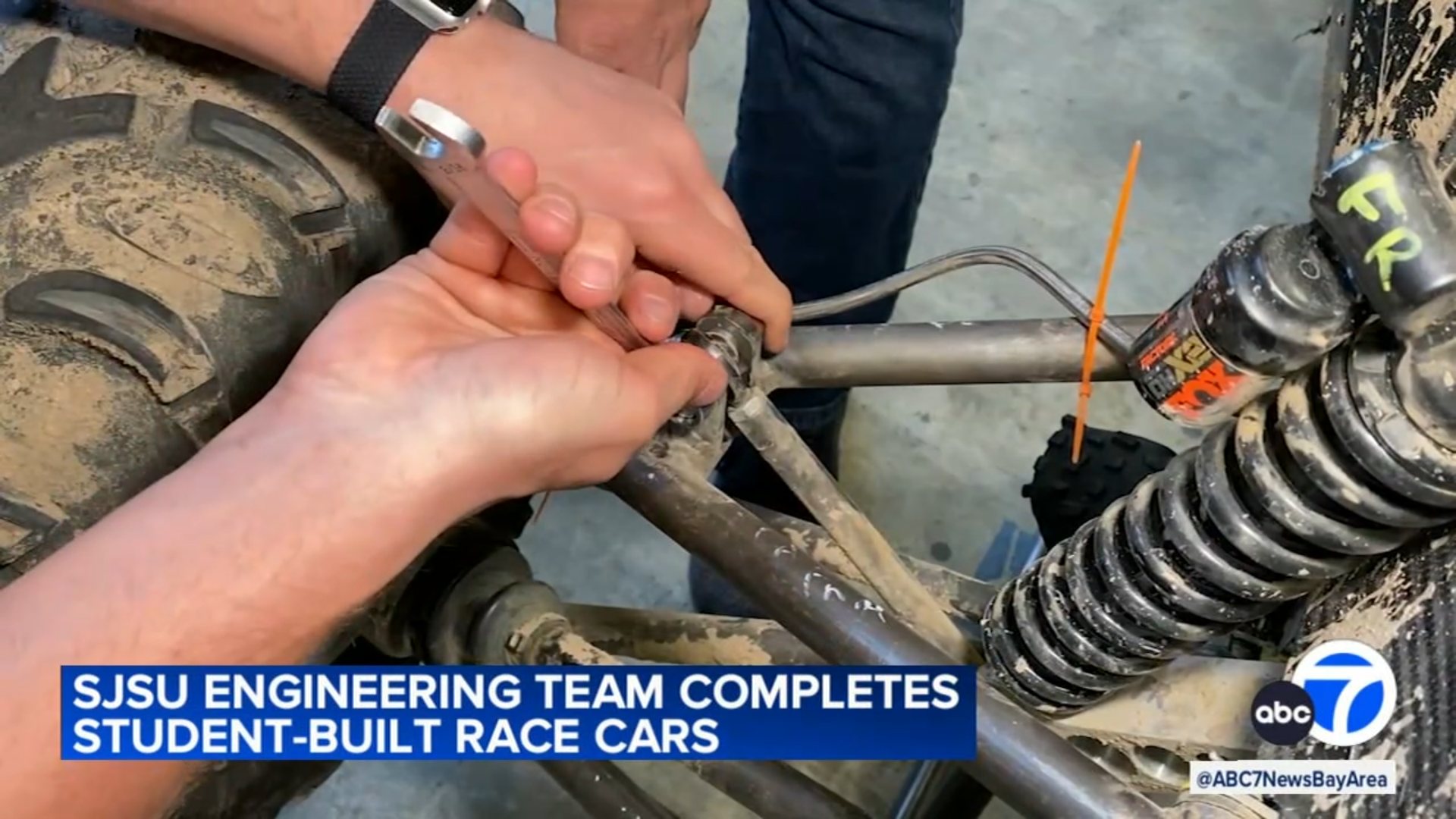 Baja club member working on car