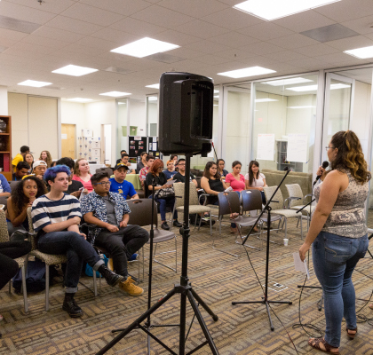 Woman talking in front of crowd