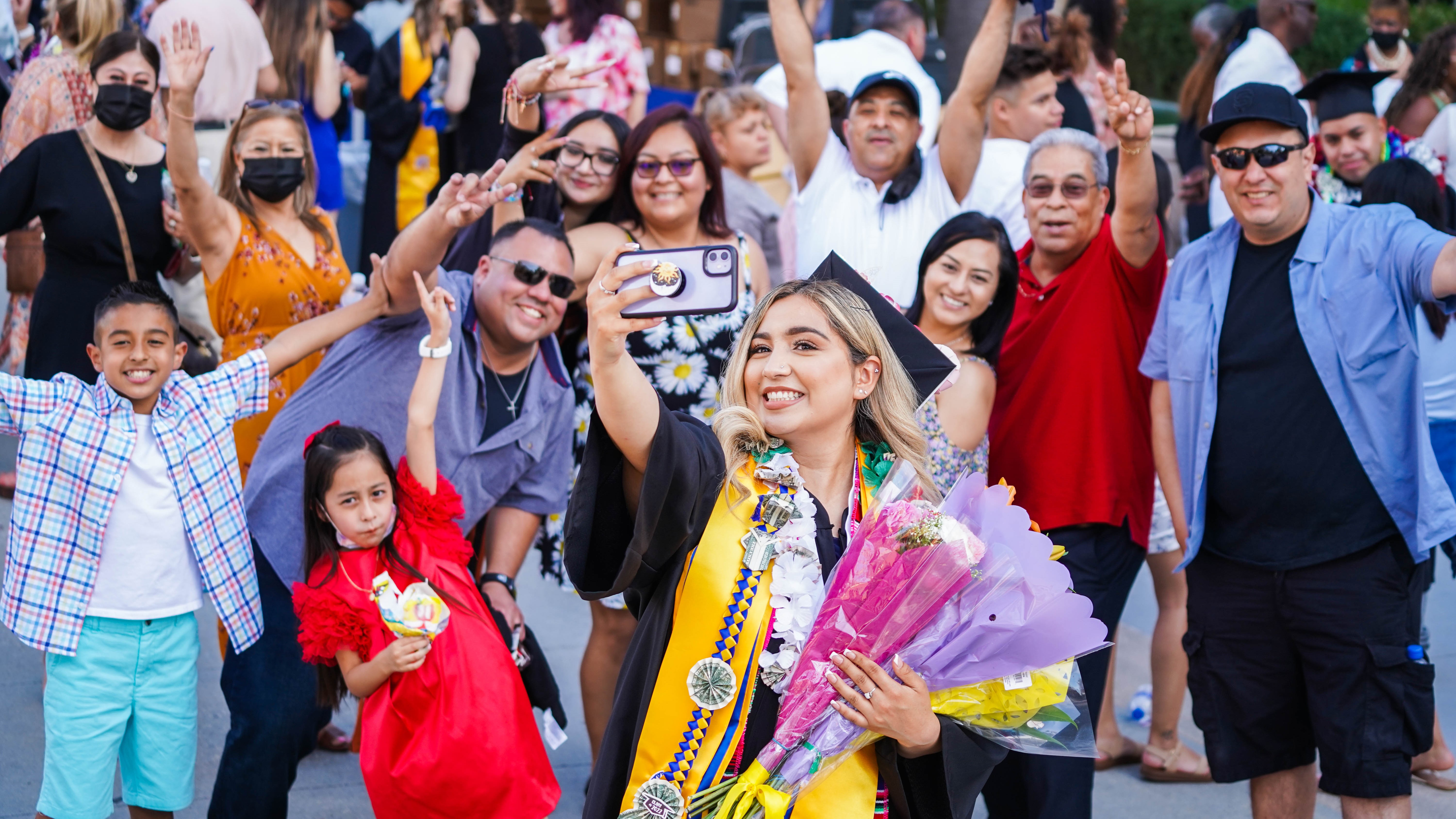 Female SJSU Student taking a picture with family