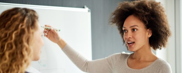 A person at the whiteboard explaining something