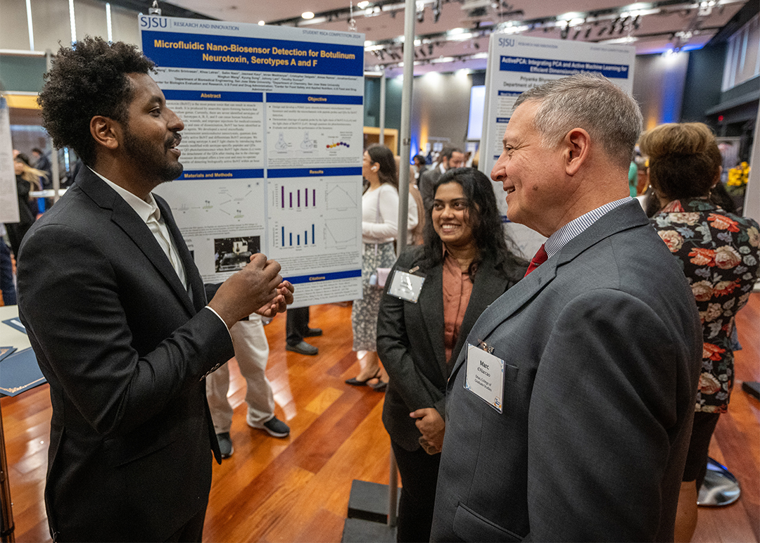 Dr. d’Alarcao with students in front of a white board.