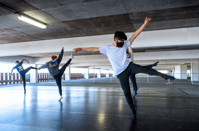 SJSU dancers mid-dance in the parking garage.