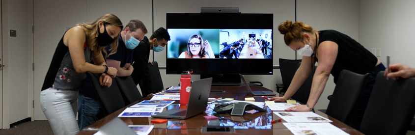 UMC staff reviewing and editing marketing materials.