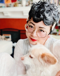 esme wang holding a dog